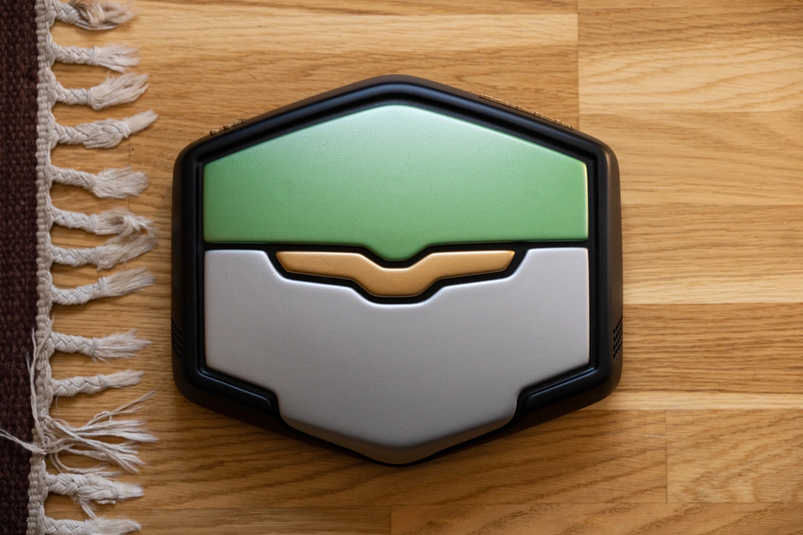 The finished green, silver and gold Moto Guzzi-inspired robot vacuum prototype