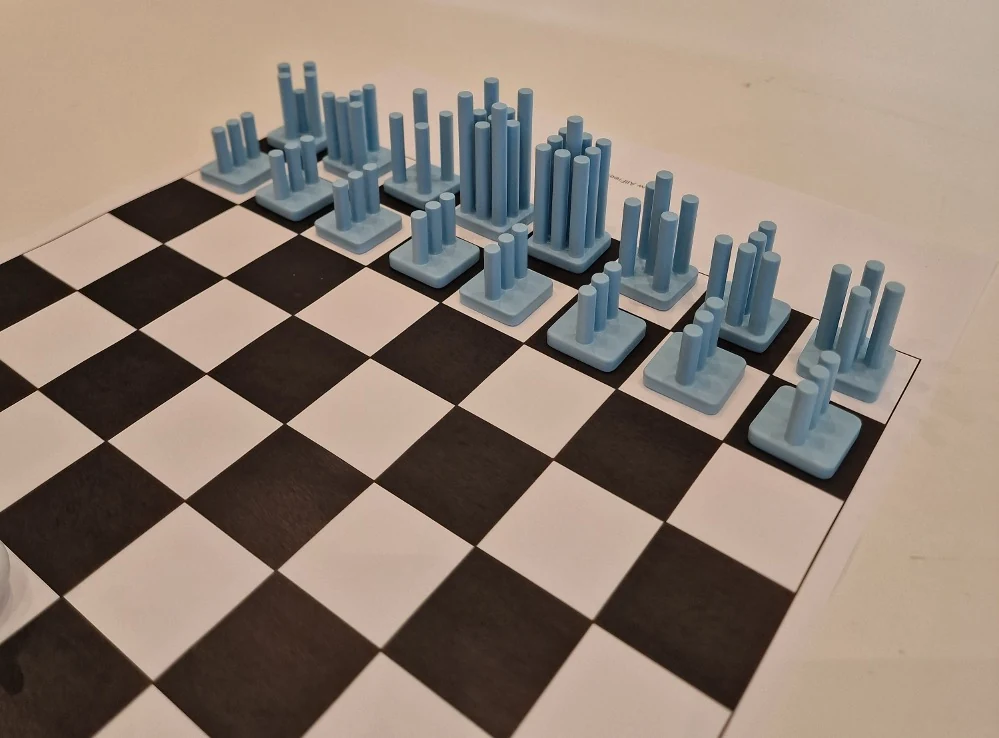 Blue 3D-printed chess pieces arranged on a chessboard