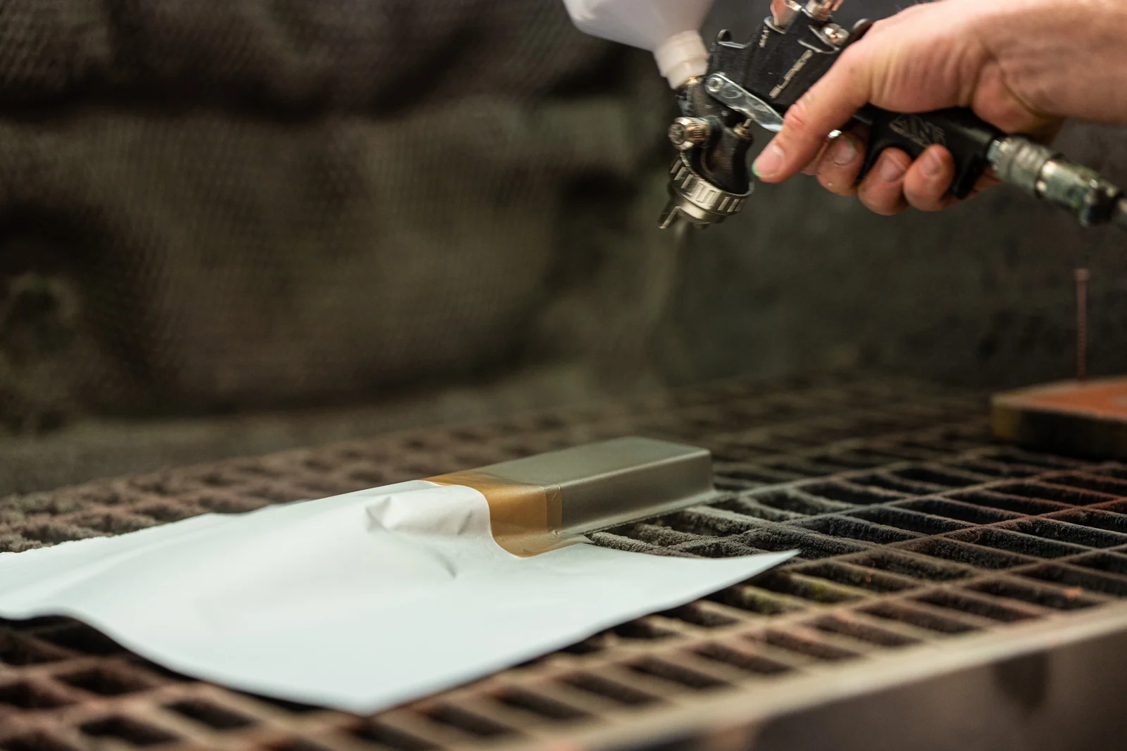Spray painting a masked panel for the Moto Guzzi prototype