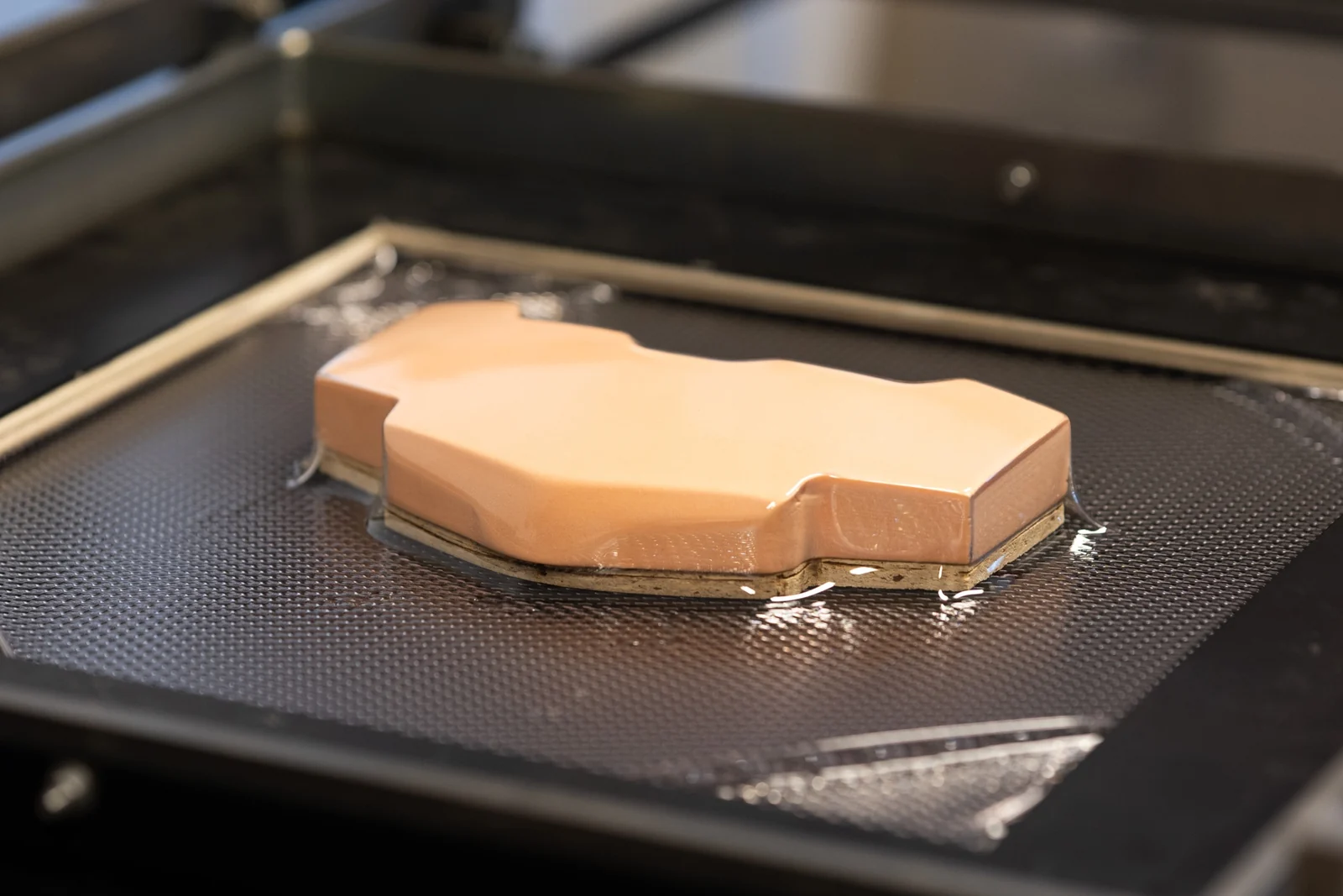 Clear plastic being vacuum formed over the milled foam shape