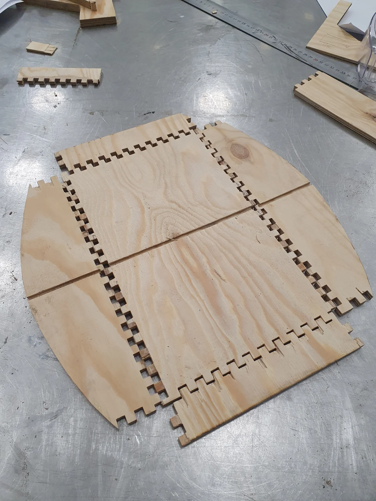 Laser-cut wooden panels and box joints on a workshop table